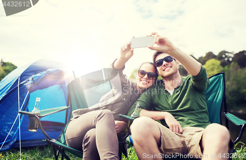 Image of couple of travelers taking selfie by smartphone