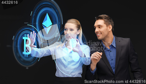 Image of businesspeople with cryptocurrency holograms