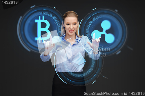 Image of businesswoman with cryptocurrency holograms