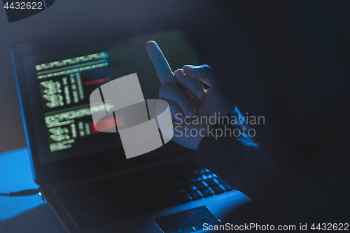 Image of hacker showing middle finger to laptop