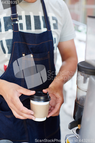 Image of Barista pouring milk in cup