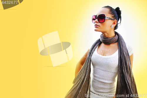 Image of woman with brown scarf on yellow background