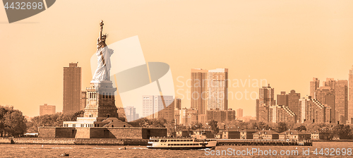 Image of Statue of Liberty with Liberty State Park and Jersey City skyscrapers in background, USA