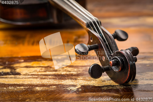 Image of Old violin in vintage style on wood background