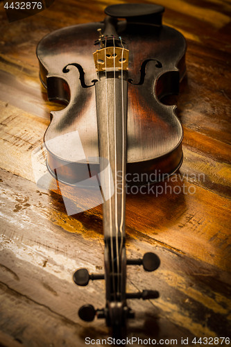 Image of Old violin in vintage style on wood background