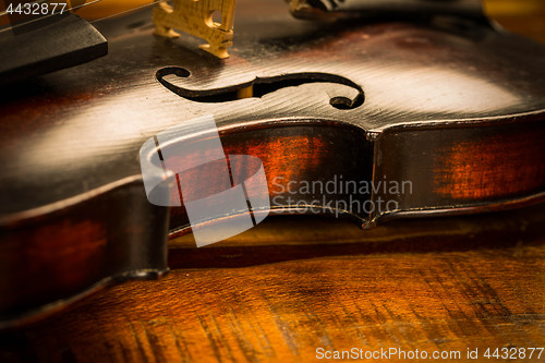 Image of Old violin in vintage style on wood background