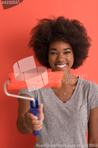 Image of black woman painting wall