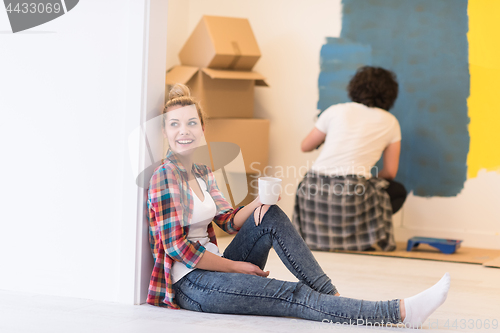 Image of young couple doing home renovations