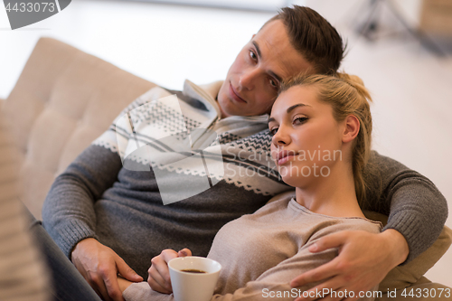 Image of Young couple  in front of fireplace