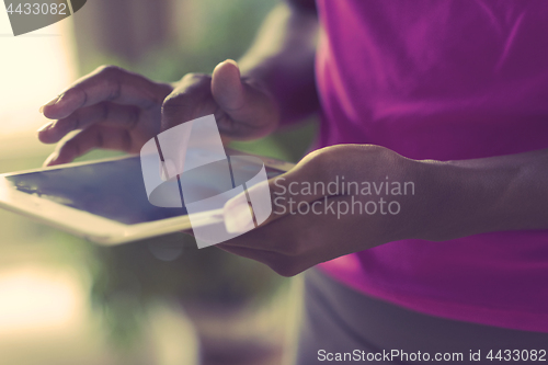 Image of african american woman using tablet