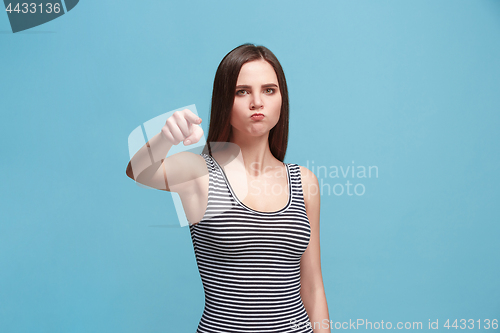 Image of The overbearing woman point you and want you, half length closeup portrait on blue background.
