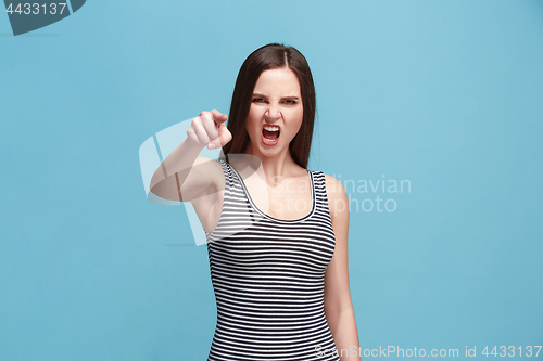 Image of The overbearing woman point you and want you, half length closeup portrait on blue background.