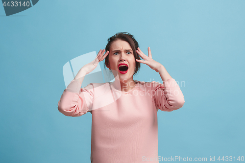 Image of Beautiful woman in stress isolated on blue