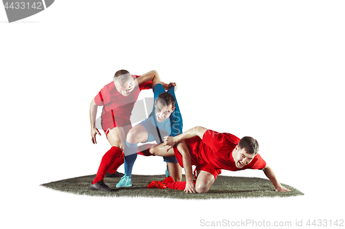 Image of Football players tackling for the ball over white background