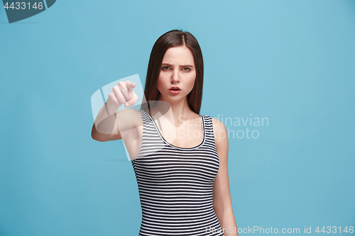 Image of The overbearing woman point you and want you, half length closeup portrait on blue background.