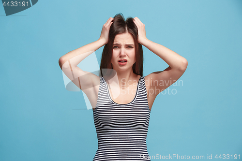 Image of Woman having headache. Isolated over pastel background.