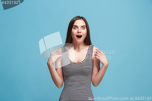 Image of Beautiful woman looking suprised isolated on blue