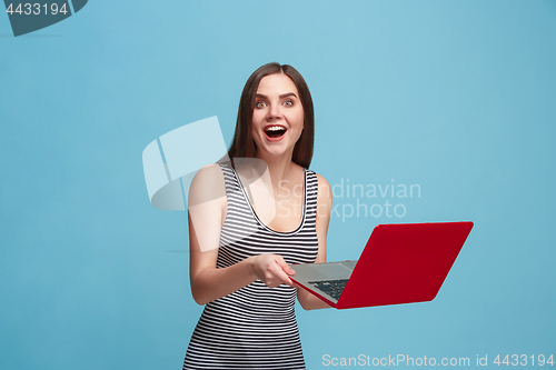 Image of Businesswoman with laptop on blue studio