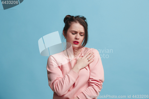 Image of Young woman overwhelmed with a pain in the shoulder