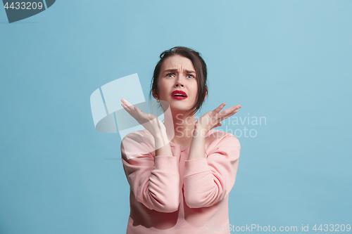 Image of Beautiful woman in stress isolated on blue