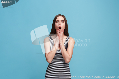 Image of Beautiful woman looking suprised isolated on blue