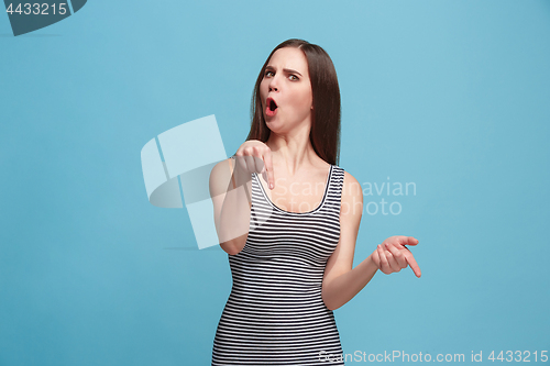 Image of Portrait of an argue woman looking at camera isolated on a blue background