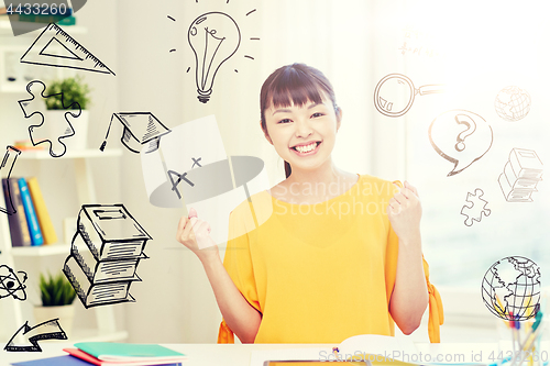 Image of happy asian young woman student learning at home