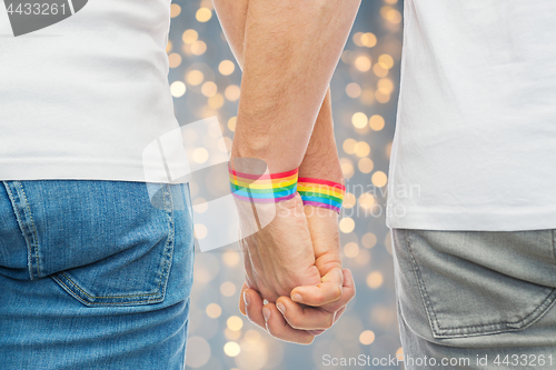 Image of male couple with gay pride rainbow wristbands