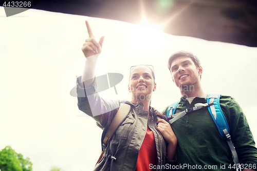 Image of smiling couple with backpacks hiking