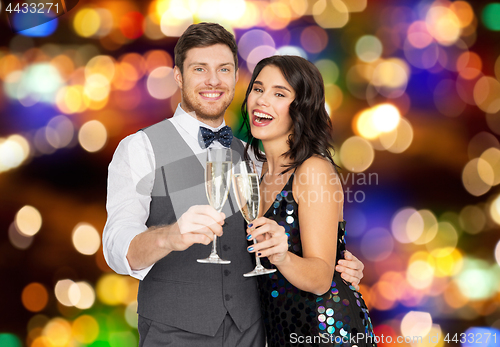 Image of happy couple with champagne glasses at party