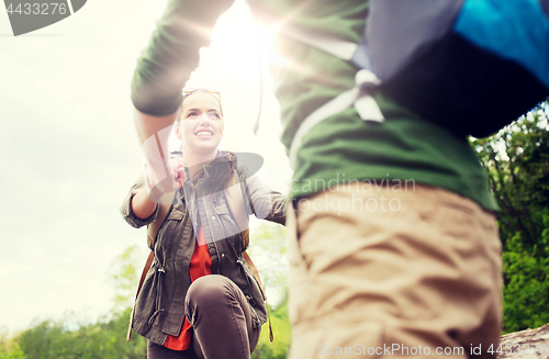 Image of smiling couple with backpacks hiking