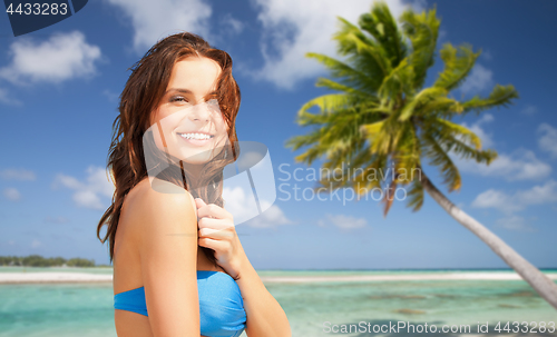 Image of happy woman in bikini swimsuit on tropical beach