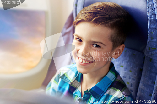 Image of happy boy travelling by plane