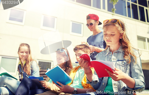 Image of group of students with notebooks at school yard