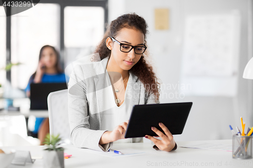 Image of businesswoman with tablet pc working at office