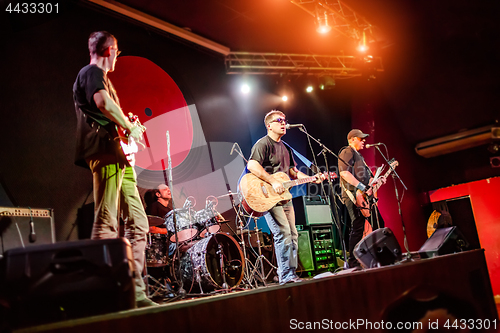 Image of Band performs on stage in a nightclub