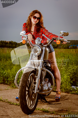 Image of Biker girl and motorcycle