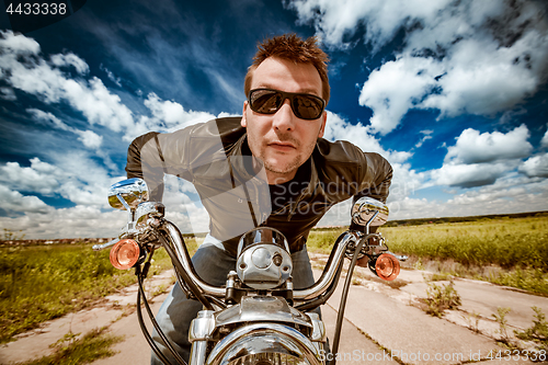 Image of Biker racing on the road