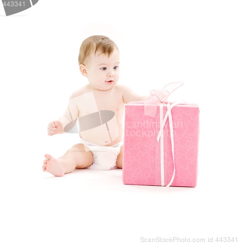 Image of baby boy in diaper with big gift box