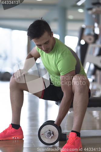 Image of handsome man working out with dumbbells