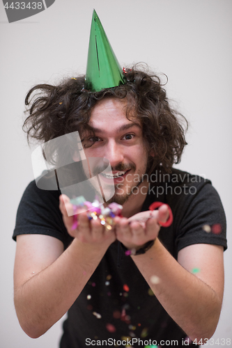 Image of man blowing confetti in the air