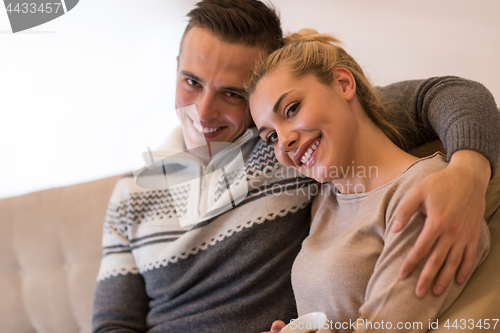 Image of Young couple  in front of fireplace