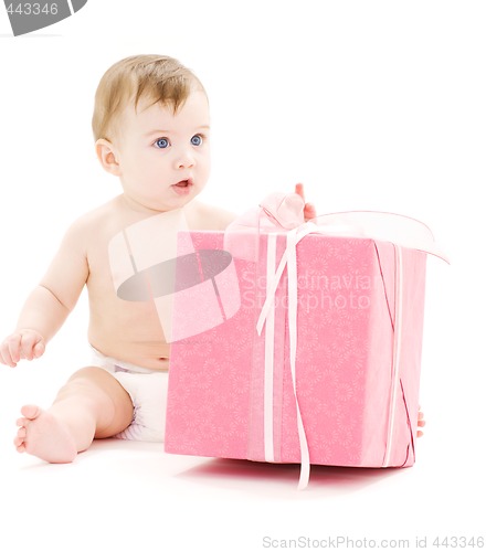 Image of baby boy in diaper with big gift box