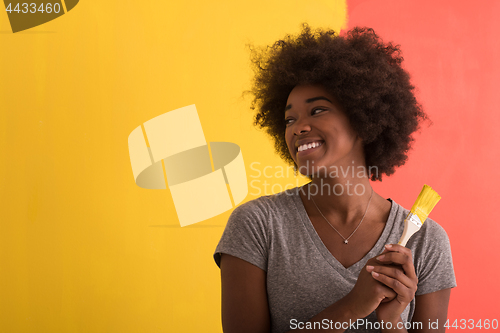 Image of black woman painting wall