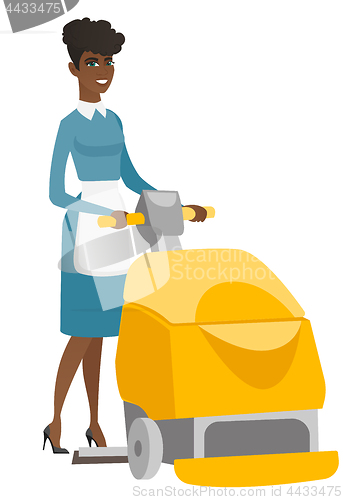 Image of African worker cleaning store floor with machine.