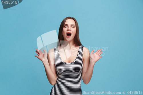 Image of Beautiful woman looking suprised isolated on blue