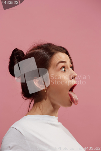 Image of The squint eyed woman with weird expression isolated on pink