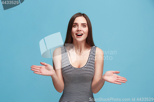 Image of Beautiful woman looking suprised isolated on blue