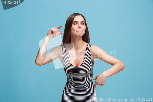 Image of Portrait of an argue woman looking at camera isolated on a blue background