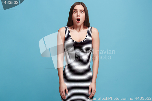 Image of Beautiful woman looking suprised isolated on blue